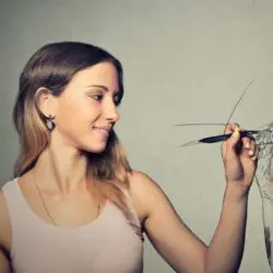 image of a young woman sketching herself