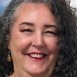 spiritual healing psychic susan from absolute soul secrets smiling with long curly hair