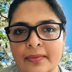 psychic suparna with dark hair tied back with soulful brown eyes