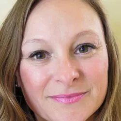 image of psychic xenia with light brown hair, long fringe and brown eyes wearing light pink lipstick