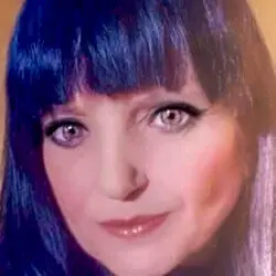 Portrait of psychic Dee Dee, a naturally gifted psychic medium with long dark hair, known for phone readings, Twin Flame guidance, and tarot insight