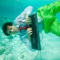 image of man with computer under the water