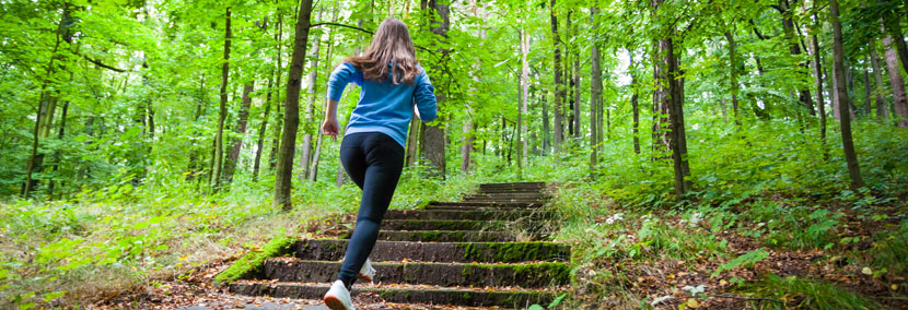 woman motivated running up the hill