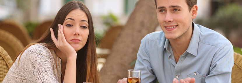 image of a woman bored at a date with a guy talking too much about himself
