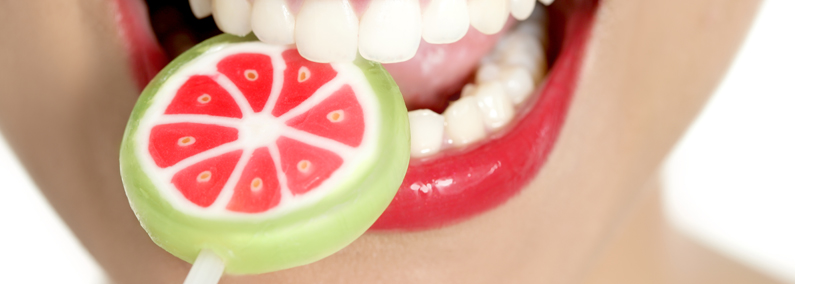 image of woman's lovely teeth eating a lollipop