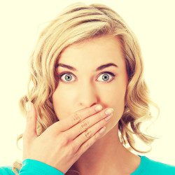 image of beautiful woman covering her mouth to hide her teeth
