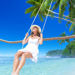 image of woman on a swing on the beach