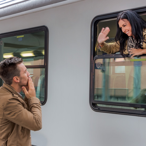 long distance relationship image of woman waving goodbye to her partner from a train