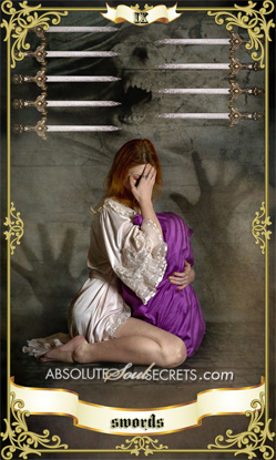 image of sad woman holding a purple blanket representing 9 of swords tarot