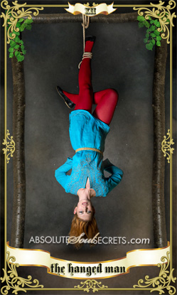 image of a woman hanging upside down representing the Hanged Man tarot card