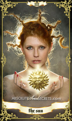 image of a woman with red hair holding a glowing sun on a tarot card