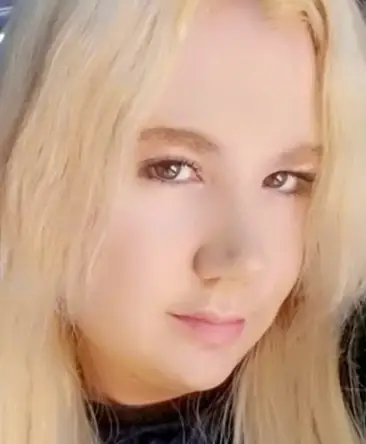 psychic Laura with blonde hair and brown eyes looking at the camera