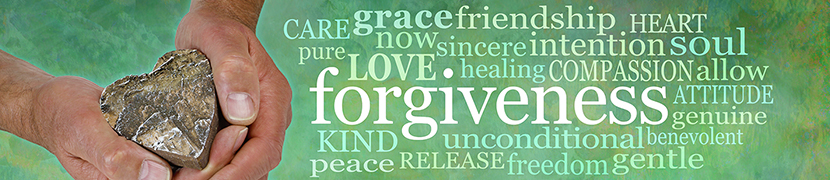 a doodle of words highlighting forgiveness and love on a green background, hands holding a crystal