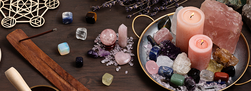 psychic protection tools laid out on a table including crystals and candles
