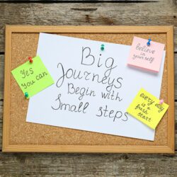 big journeys begin with small steps message on a corkboard