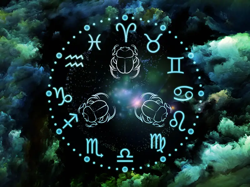Jade blue astrology symbols arranged in a circle with 3 beetle like creatures in centre, all on a green and black background