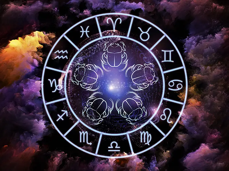 Blue zodiac wheel on a pink, purple and black background