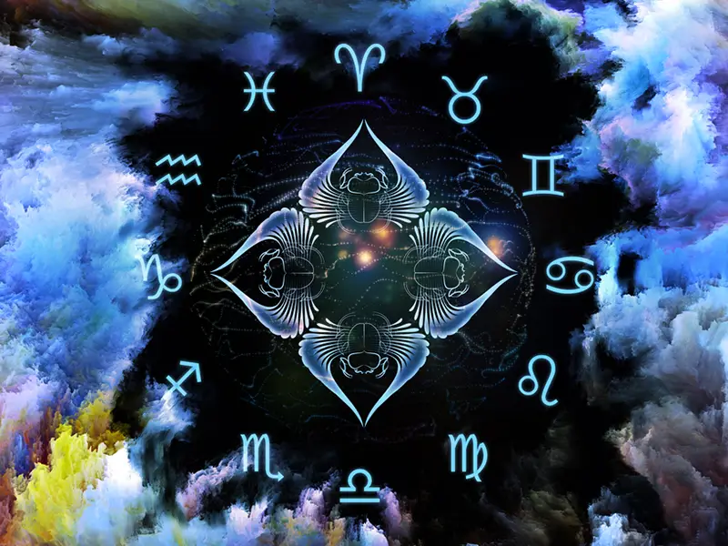 blue astrology symbols in a circle with winged angel like creatures in the centre, all on blue and black background