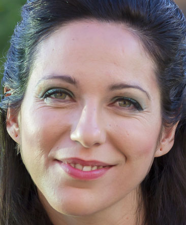 Our guest secret psychic has long brown hair half tied up and green eyes smiling at the camera