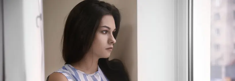 a woman alone, grieving, and looking at a distance