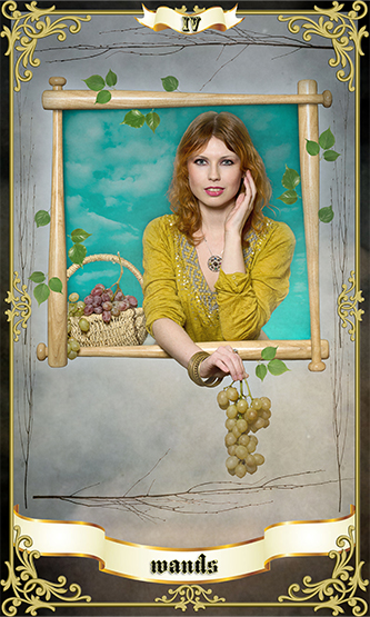 Tarot card illustration of the Four of Wands featuring a woman in a yellow dress holding grapes, with a basket of fruit and a bright sky background.
