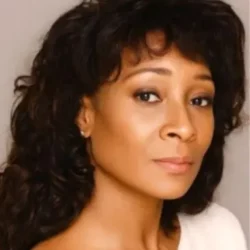 Psychic Carolyn with dark hair and cream top id 2017