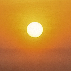 Bright golden sun glowing in an orange sky, symbolising warmth, clarity and new beginnings.